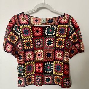Medium sized woven, waist length top. Colorful.